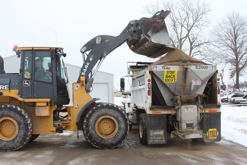 Clifton Stockhorst, a 6-year employee with the City of Moberly's Street Department, drives a John Deere 544K Wheel Loader tractor with a bucket to load a supply of salt mixture into a dump truck with a rear spreader Wednesday morning. With additional snowfall in the forecast, the substance will be used  to apply to city streets to help melt incy roadways and provide some traction for better travel by vehicles.