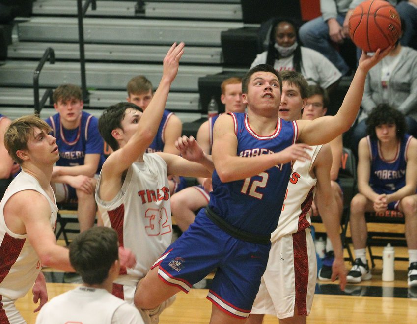 Moberly senior guard Dominic Stoneking finds a seam  in the middle of the lane between four Kirksville players as he attacks the rim in trying to score Saturday. Stoneking and the Spartans suffered an 85-53 loss to Kirksville in the boys championship game of the Macon Tournament.
