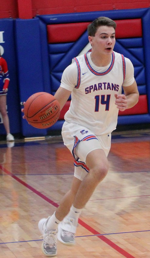 Moberly senior forward Toby Short jets off with the basketball in transition during a Jan.5 home game. Short scored eight points Thursday to help the Spartans upset Class 5 third-ranked and previously undefeated Mexico 77-71 in the semfinals of the Macon Tournament.