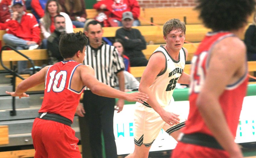 Westran senior guard Caleb Nagel (white jersey) dribbles to his left toward the top of the key. Nagel scored 11 points Tuesday to help the Hornets boys knock off North Shelby of Shelbyville 72-47.
