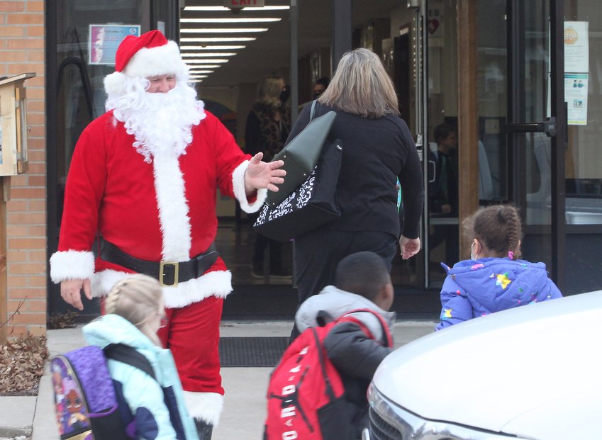 Santa Claus (Travis Mitchell) greeted and brought some Christmas cheer early Thursday morning to elementary students arriving to Moberly's South Park School. Mitchell, a Moberly police officer, has been putting on the suit for 10 years and visits children at several school buildings within Randolph County each holiday season.