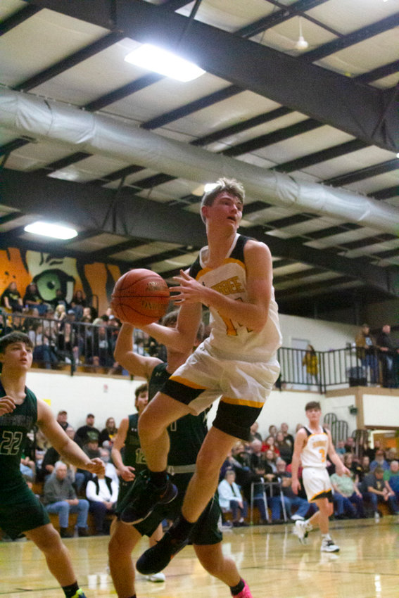 Higbee&rsquo;s Jordan Fuemmeler drives the lane, looking to pass the ball as the Tigers defeated Tina-Avalon 72-37 Friday night. (All photos by Michael Allshouse)