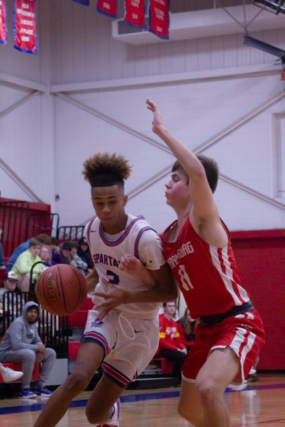 Spartan Demarcus Gilson drives past a defender. Gilson had 10 points for Moberly.