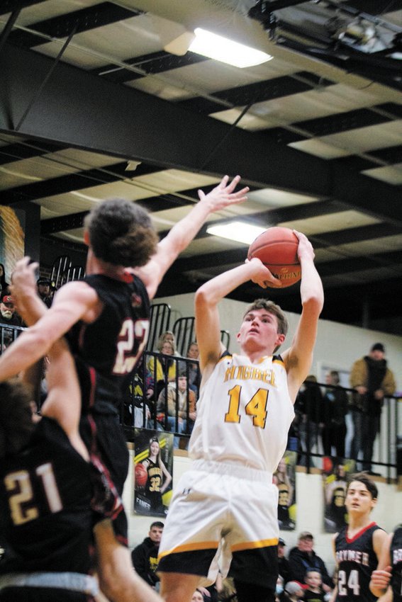 Higbee guard Jordan Fuemmeler goes up for a shot in a crowd of defenders. Fuemmeler had a game-high 38 points.