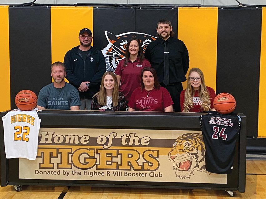 Higbee senior Macey Whisenand, front row second from left, signed a letter of intent to play basketball at Central Christian College of the Bible in Moberly on Feb. 11. Also pictured seated with Whisenand are her parents, Jonathan and Brandy Whisenand and her sister, Alexis. Back row, from left, CCCB assistant coach Allen Maltsberger, CCCB head coach Kori Zarzutzki and Higbee head coach Tanner Burton.