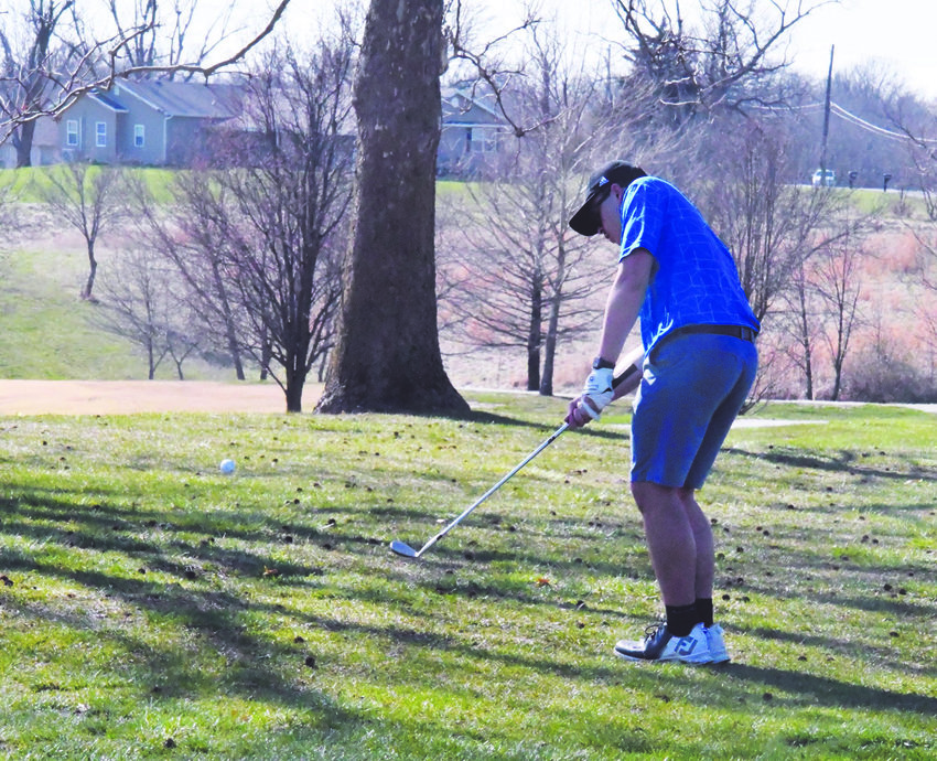 Isaac Stoneking hits a chip shot during a triangular match held Friday at Heritage Hills Golf Club. Stoneking shot a team-best 44 to lead the Spartans.