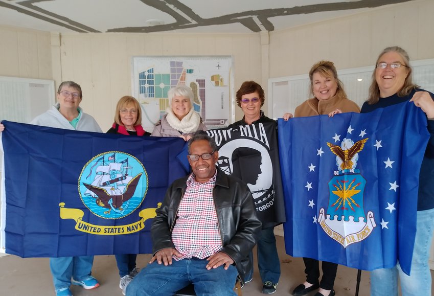 The Altrusa International Club of Moberly Patriotism Committee recently donated service flags to the Moberly Veterans' Flag Project. These flags will be displayed at Oakland Cemetery on Honor Drive. Pictured from left are Altrusa members Janie Riley, Joyce Deck, Joan Snodgrass, Kristee Ornburn and Lynn Truesdell and Flag Project representative Dorothy Latson. Art Latson is seated in front.