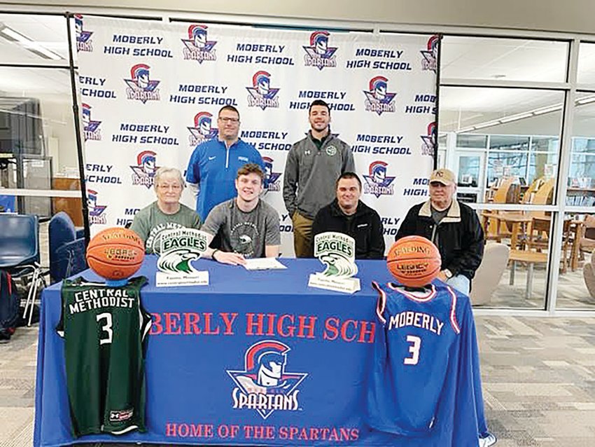Moberly High School boys&rsquo; basketball player Zayne Montgomery signed to continue his career at Central Methodist University last week. He was joined by (front row) his grandmother, Linda, father, Jared and grandfather Harold Montgomery and (back row) Moberly head boys&rsquo; basketball coach Cord Hagedorn and CMU graduate assistant coach Trent Short.