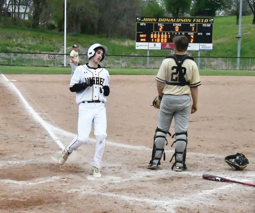 Higbee&rsquo;s Jaxon Hudson touches home plate with his left foot after tagging up from third base on Derek Rockett&rsquo;s fly ball out at John Donaldson Field in Glasgow Tuesday. The Tigers gave the Yellowjackets all they could handle before falling, 4-3.
