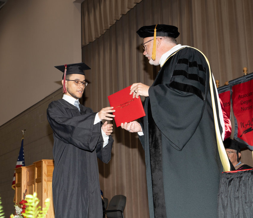 A Moberly Area Community College graduate accepts his diploma from College President Jeff Lashley during Saturday morning ceremonies in Moberly. The college awarded degrees and certificates to more than 800 students over two days.