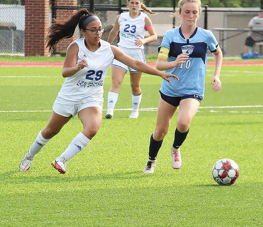 Moberly freshman defender Alexis Cooper attempts to clear the ball away from Father Tolton&rsquo;s Macie Parmer during Tuesday&rsquo;s Class 2 District 6 semifinal girls&rsquo; soccer game at Mexico High School.