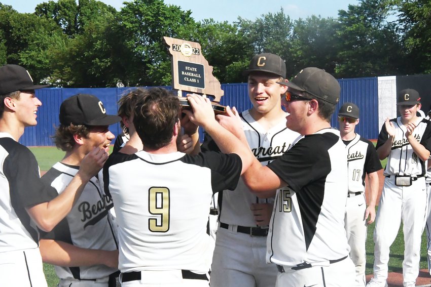 Cairo&rsquo;s Jack Prewett (9), Gage Wilson (25) and Tyler Davis (15) hold the Missouri State High School Activities Association Class 1 baseball third-place trophy in unison after Tuesday&rsquo;s 9-3 victory over South Nodaway at U.S. Baseball Park in Ozark.