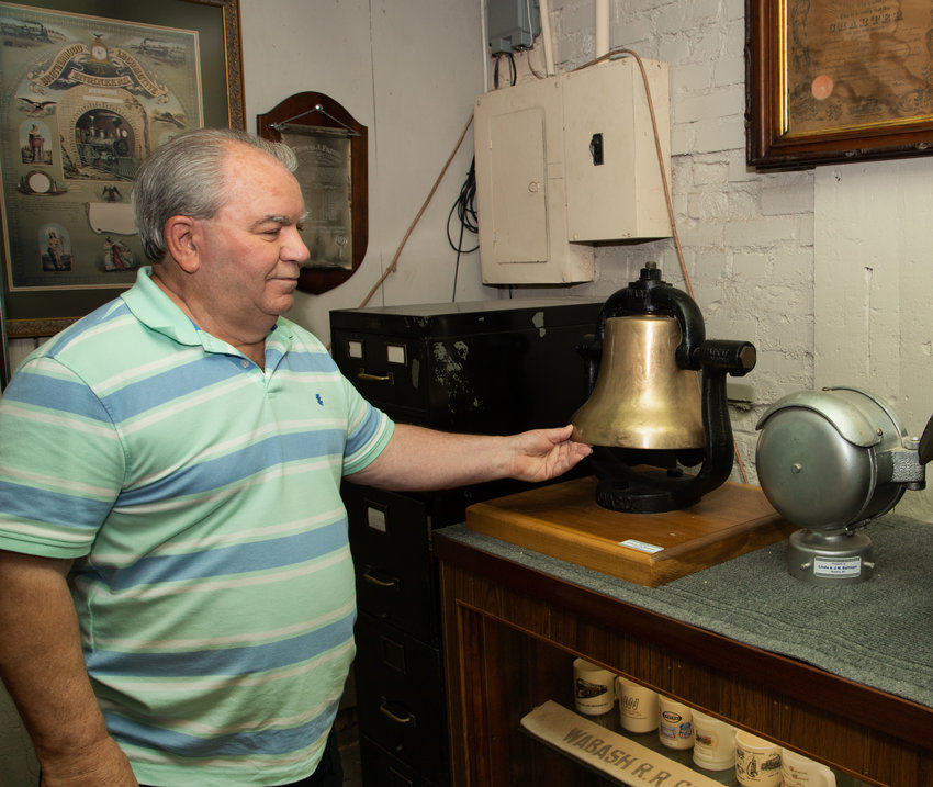 Cecil Elliott, the new curator of Moberly&rsquo;s railroad museum, stops a train bell after ringing it. The bell is one of many pieces of railroad history on display in the old freight building on North Sturgeon Street in Moberly.
