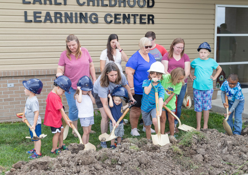 In this July file photo, children help break ground for an addition to the Early Childhood Learning Center in Moberly. The foundation and concrete floor have been poured, according to a report from the architects during Tuesday's school board meeting.