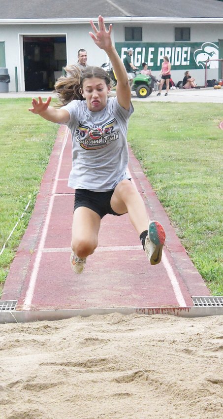 Cairo High School athlete Journey Sander works on her triple jump form during a one-day camp on Monday, July 25, at Davis Field on the campus of Central Methodist University in Fayette.