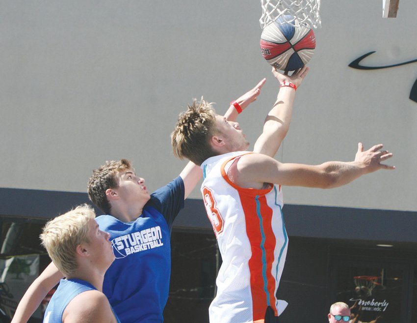 In this September 2021 file photo, Carter Briscoe of Clark County goes for a layup during the Gus Macker 3-on-3 Basketball Tournament in Moberly.