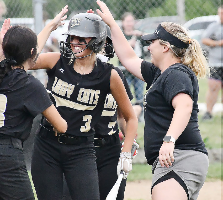 Iszy Zenker (3) celebrates with Cairo assistant softball coach Jennifer Matthews after Zenker smacked a three-run home run during Monday's game versus Westran in Huntsville. The Bearcats topped the Hornets, 12-7.