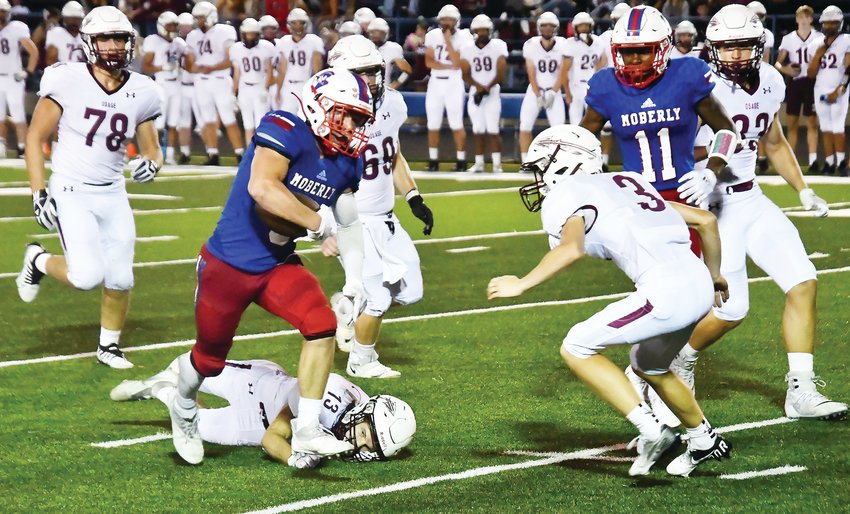 Moberly running back Gage St. Clair (9) eludes a tackler en route to scoring a TD in a Friday, Sept. 2 game in Moberly. St. Clair rushed for more than 100 yards for the first time this season in a 43-37 Spartan win.