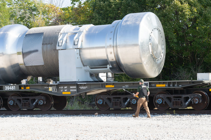 A federal agent checks radiation levels of a shipping container in a simulated train accident Wednesday involving spent nuclear fuel. The exercise allowed federal, state and local agencies to test their preparedness for a real emergency.