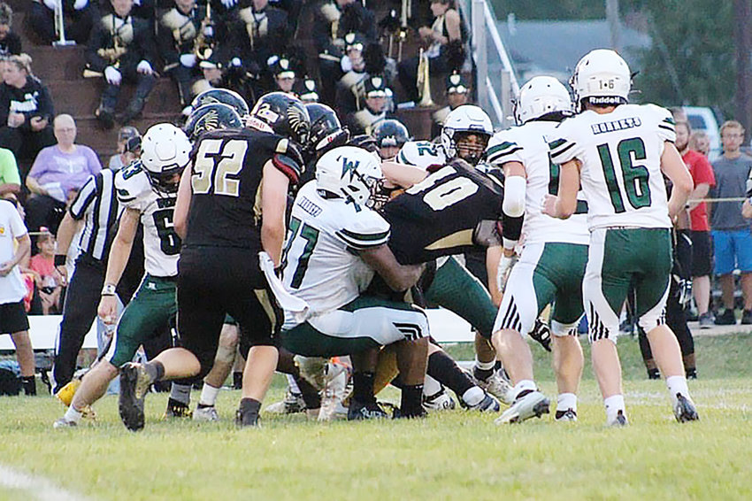 Westran&rsquo;s Tarayle Wallace (77) and teammates swarm to tackle a Fayette fullback D.J. Moore (40) during Friday&rsquo;s game in Fayette. The Falcons topped the Hornets, 21-18.