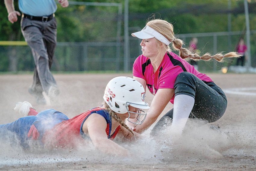 Moberly&rsquo;s Chloe Ferguson slides into third base safely before Mexico third baseman Abby Bellamy has a chance to apply the tag during Tuesday&rsquo;s North Central Missouri Conference game at Gallop Field in Mexico. The Spartans suffered a 12-11 loss to the Bulldogs, snapping a four-game winning streak.