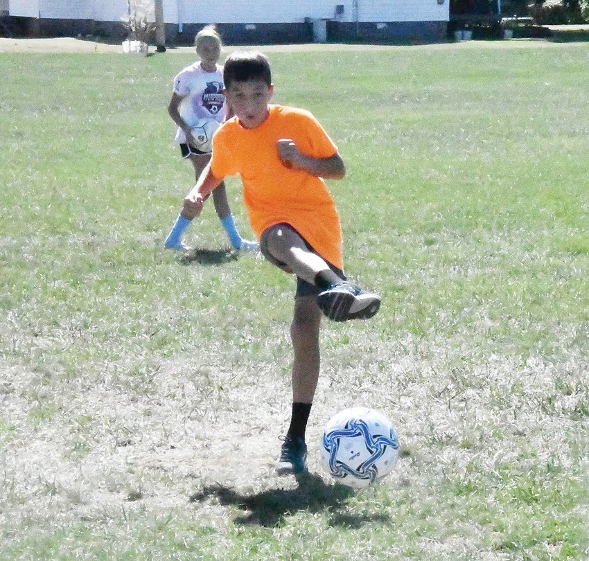 Division winner Aaron O'Loughlin kicks the ball toward the goal during the Knights of Columbus Soccer Challenge on Saturday, Sept. 24.
