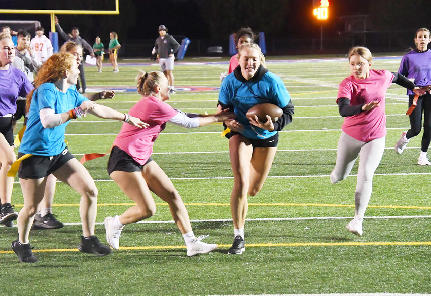 Moberly junior Asa Fanning runs up the middle past the senior team's defense for a touchdown during Wednesday's Powder Puff round robin at Dr. Larry K. Noel Spartan Stadium.