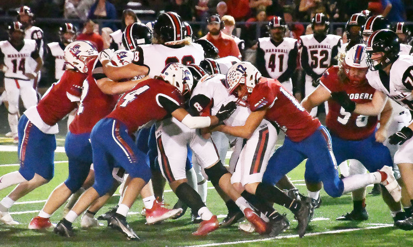Moberly High School's Jonah Black (left) and Kemper Powell are part of a gang effort to tackle Marshall quarterback Jaxson Case during Friday's North Central Missouri Conference football game at Dr. Larry K. Noel Spartan Stadium. The Owls downed the Spartans, 17-7, turning Homecoming sour for the hosts.
