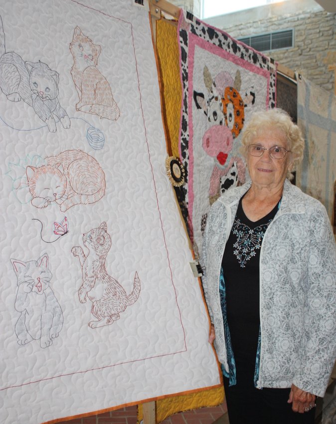 Louise Armstrong, of Paris, stands with the baby quilt that earned her a first-place award at the Salt River Quilt Show.