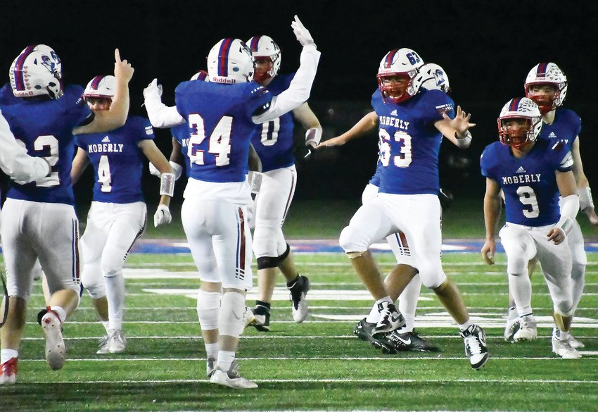 Moberly High School football players celebrate after beating Mexico, 28-14, on Friday night at Dr. Larry K. Noel Spartan Stadium. Pictured are Zach Cox (63) and Gage St. Clair (9).