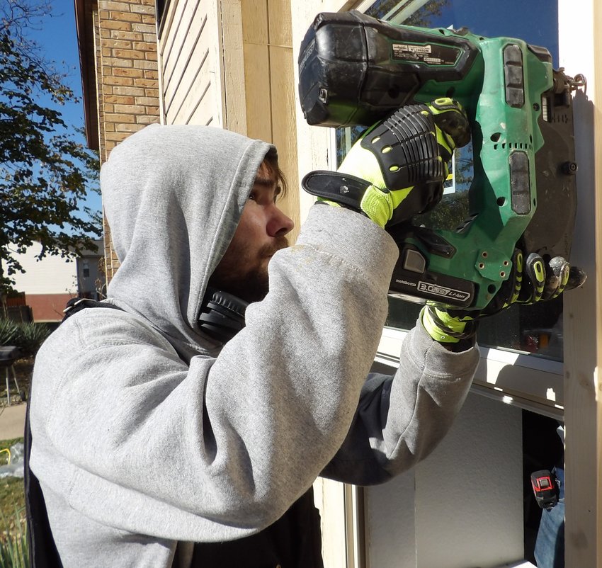 North East Community Action Corporation Weatherization Specialist Andy Mackey installs a window.