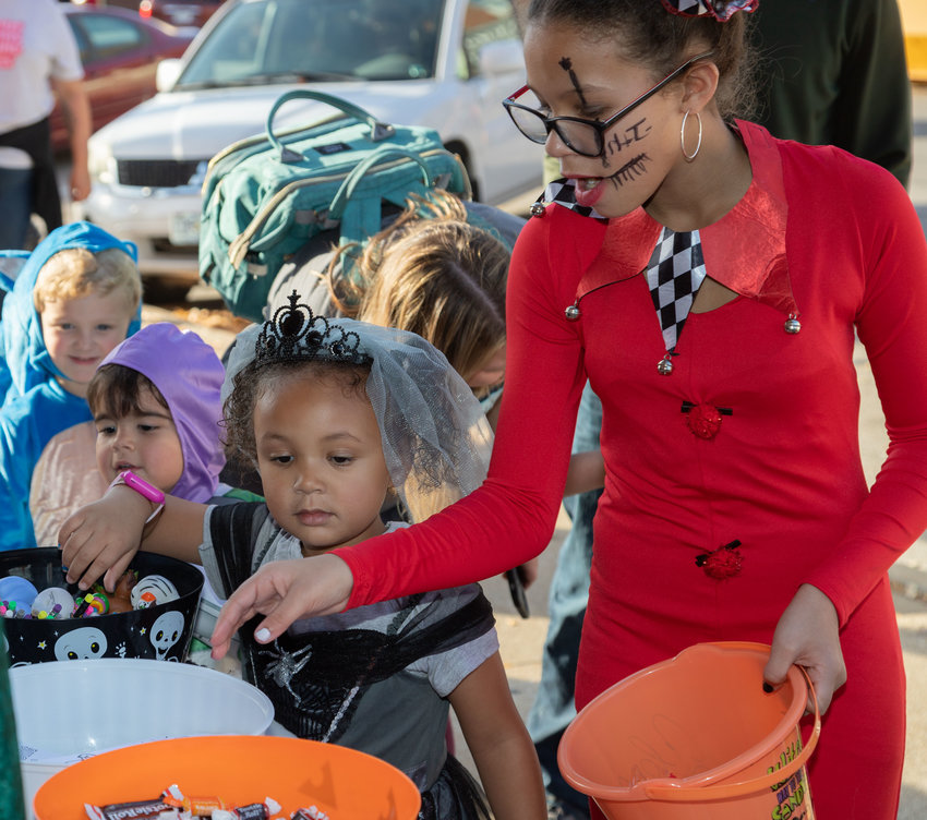 Jazzmyne and Alena Bradford pick their favorite candies during the Moberly Parks and Recreation Trick-or-treat Trail Monday.