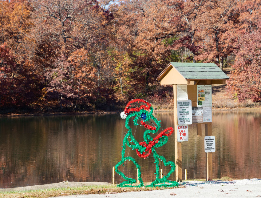 A Christmas display waits for power on the shore of Rothwell Lake. Christmas lights through Rothwell Park will light up for carloads of visitors from 5-9 p.m Nov. 27 through Dec. 23.