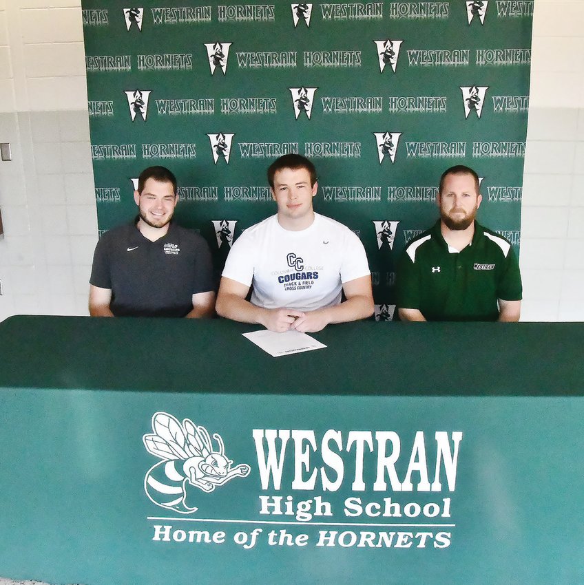 Westran High School thrower Brenin Howell is flanked by Columbia College assistant track and field coach Mason McCaleb and Westran head coach/athletic director Aaron O'Laughlin during a signing ceremony on Thursday, Nov. 10, in Huntsville.