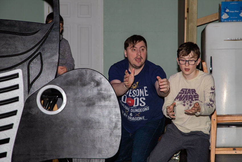Ralphie and his dad watch the lug nuts for a tire disappear into the darkness during a rehearsal for the 4th Street Players&rsquo; production of &ldquo;A Christmas Story&rdquo; Tuesday. The Old Man is played by Leo Hammond. Sullivan Smith is young Ralphie.