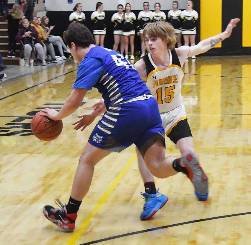 Higbee's Chad Crawford (15) plays tough defense on Southwest's James Dake during a Carroll Livingston Activities Association boys basketball game on Thursday, Jan. 5. The Tigers topped the Wildcats 81-40.