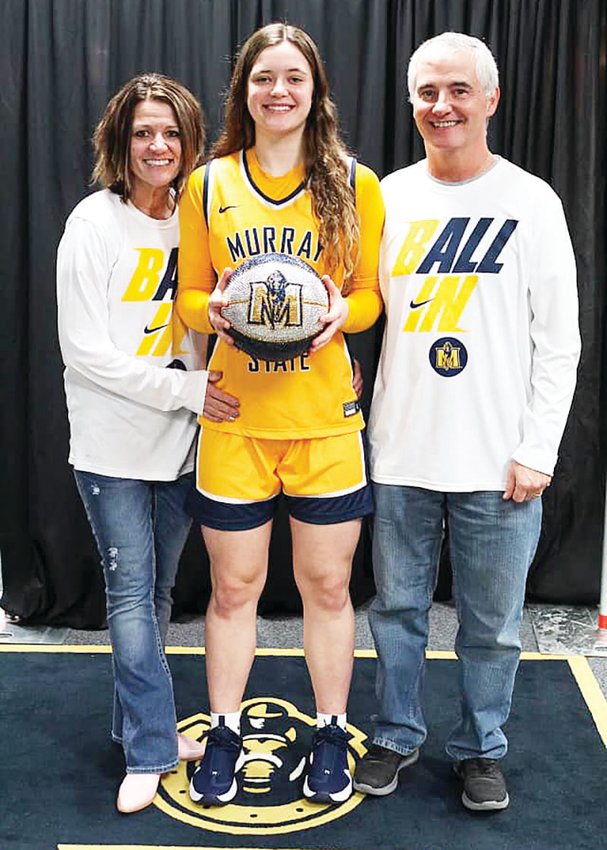 Moberly junior combination forward/guard Grace Billington shows off her Murray State University uniform along with her parents, Anne and Kelly, modeling some Racer gear as well.