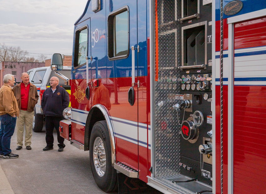 Moberly City Councilman John Kimmons, County Bank&rsquo;s Kal Cleavinger and Moberly Fire Chief Don Ryan talk in front of the new Moberly fire truck before Tuesday&rsquo;s city council meeting.
