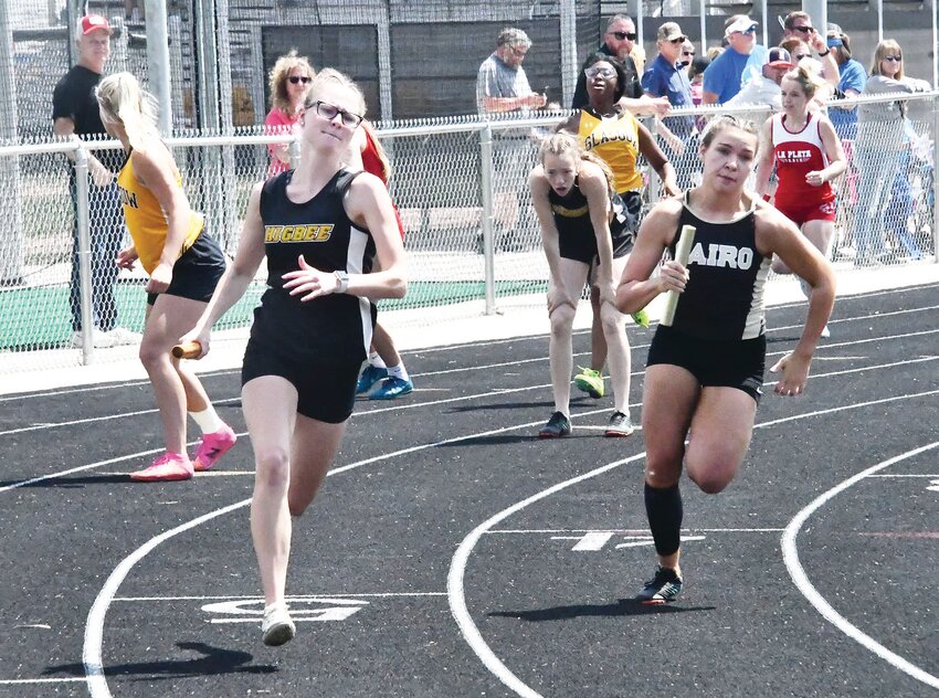 Higbee's Hailey Derboven (left) and Caroline Ellison of Cairo compete during the Class 1 District 3 girls 4x100-meter relay last Saturday at Bob Monnig Track in Glasgow. Cairo finished first and Higbee was third. Both teams move on to the sectional round next Saturday in Shelbina.