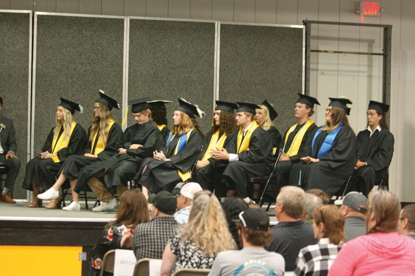 Higbee High School seniors await receiving their diploma during Friday&rsquo;s graduation ceremony.