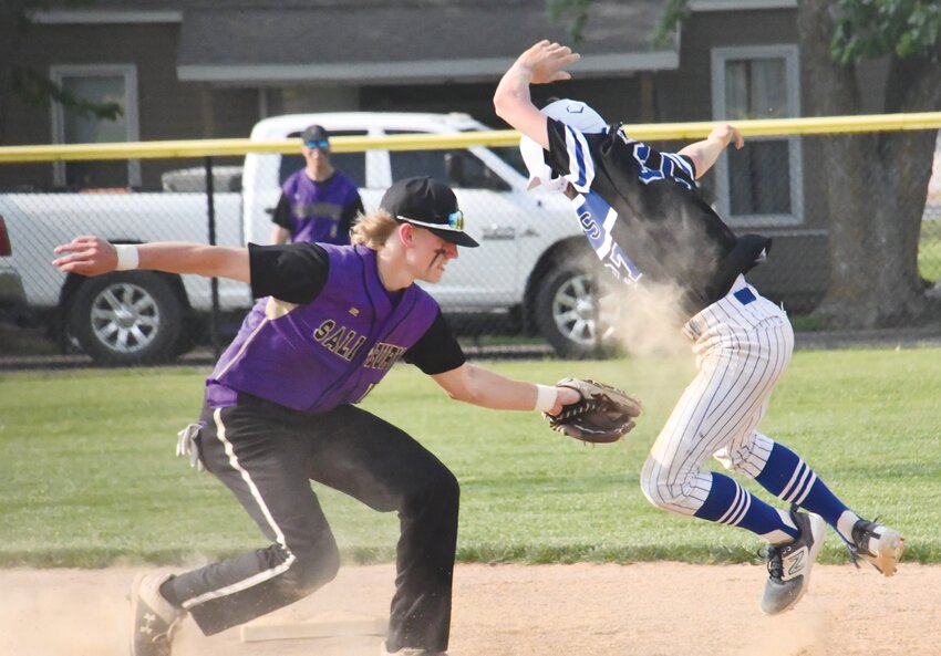 Salisbury's Eli Wekenborg (purple jersey) tags out Putnam County's Brayden McReynolds during a Class 2 state quarterfinal game in Unionville on Wednesday, May 24.