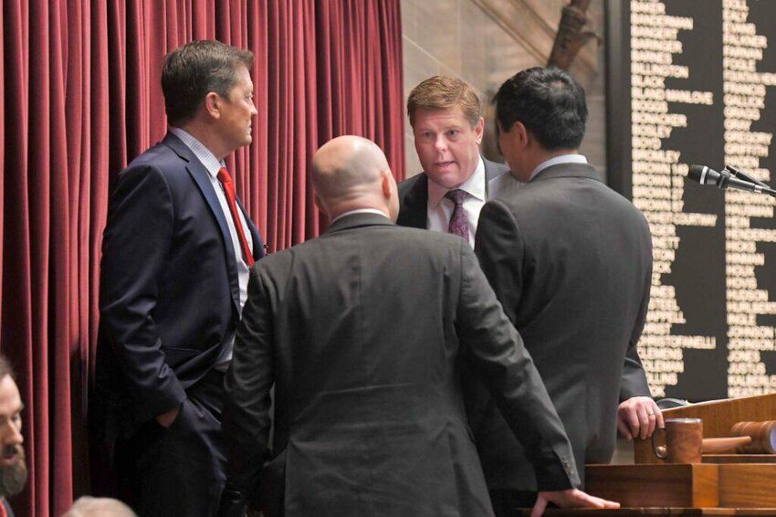 House Speaker Dean Plocher, R-Des Peres, center, speaks with, from left, Speaker Pro tem Mike Henderson, R-Bonne Terre, Budget Committee Chairman Cody Smith, R-Carthage, and Majority Leader Jonathan Patterson, R-Lees Summit, during a March debate on the state budget. (Tim Bommel/Missouri House Communications)