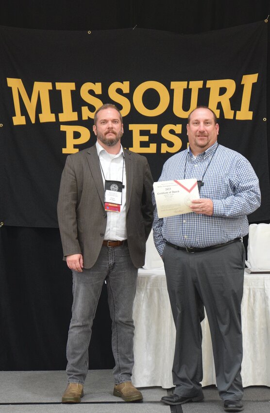 Moberly Monitor-Index Publisher Tim Schmidt, right, accepts two awards presented to the newspaper for their work in 2022 at Saturday&rsquo;s Missouri Press Association Better Newspaper Contest luncheon.. Also pictured is Amos Bridges, editor-in-chief of the Springfield News-Leader and Missouri Press Association acting president. Submitted photo.