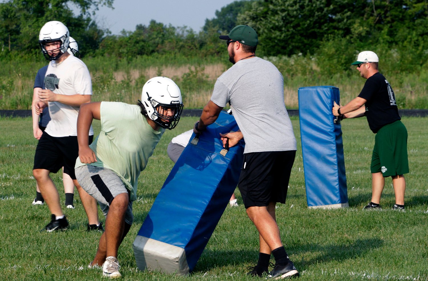 Westran head football coach Aaron O'Laughlin, right, and Hornets assistant coach Alex Thomas hold blocking dummies as they observe players as they work through practice drills. Westran went 9-2 a year ago and opens its 2021 ledger Aug. 27 by making about a 15-mile road trip to battle Lewis &amp; Clark Conference rival Salisbury.