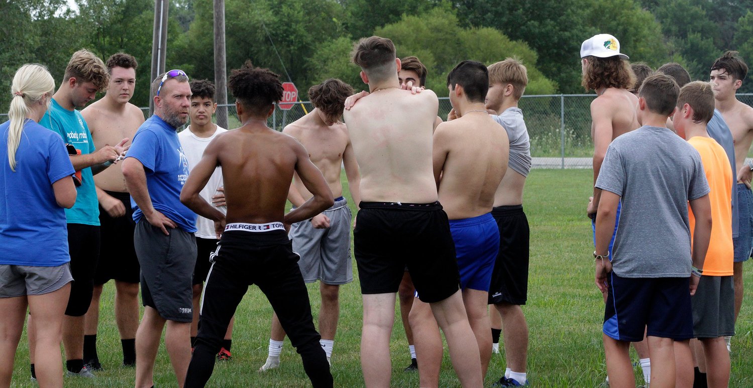 Moberly Spartans boys head soccer coach Ben Hays, left, encourages his 28 members of his team about their work ethic following an early morning preseason practice held Aug. 13. The soccer Spartans snapped a 5-year losing skid last fall to finish at 10-8-1 and Hays believes the 2021 campaign to be much improved.