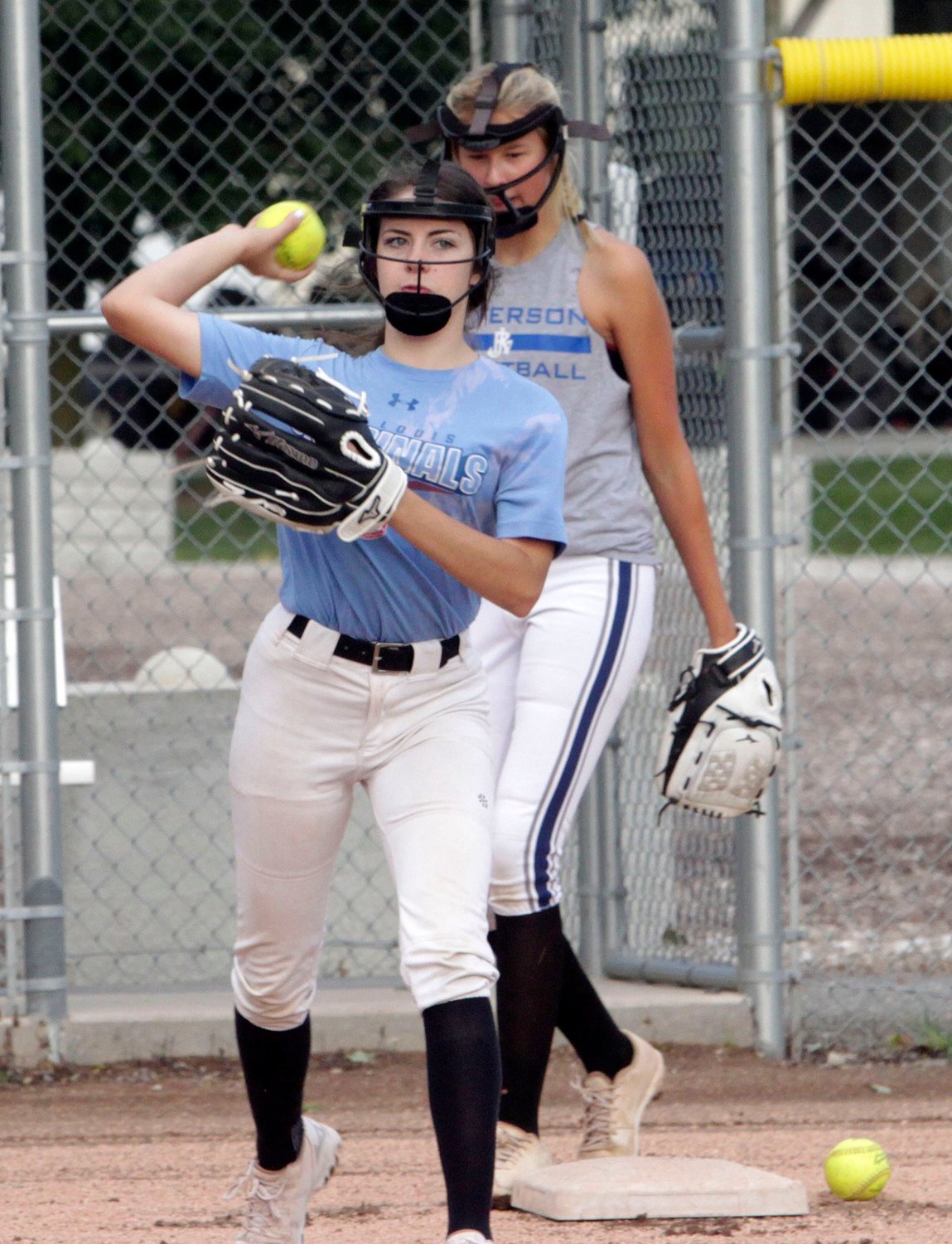 Darcy Pierce, a Cairo junior pegged to be the Lady 'Cats starting catcher this 2021 fall campaign, makes a throw during a preseason morning workout Wednesday, Aug. 11. Standing behind her is fellow junior Iszy Zenker who returns to start at second base.