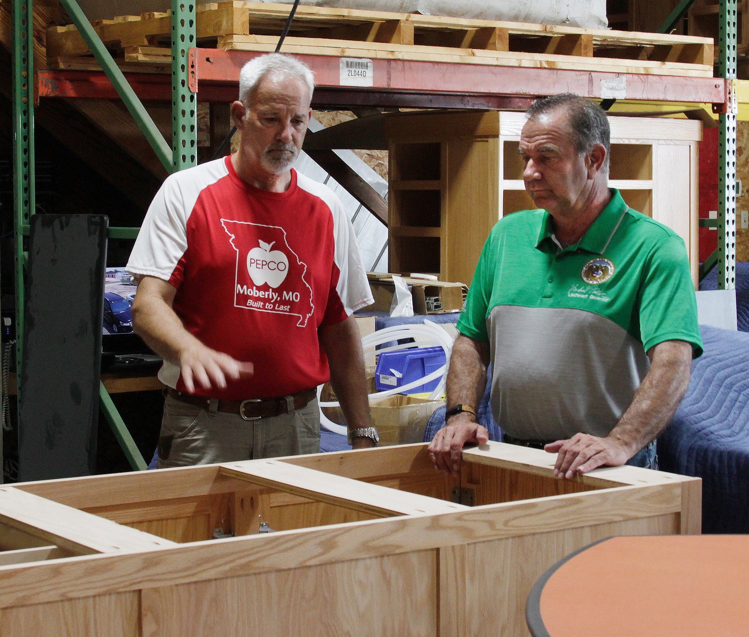 Missouri Lt. Governor Mike Kehoe, left, listens to PEPCO owner Dave Patton explains the process of how his company makes a custom-made classroom lab work table that will be shipped to a school district customer. Kehoe visited PEPCO ( Patton Educational Products Co.) on Tuesday, July 27 to learn more about its business operation and because the business is one of about 450 members of the state's Buy Missouri program.
