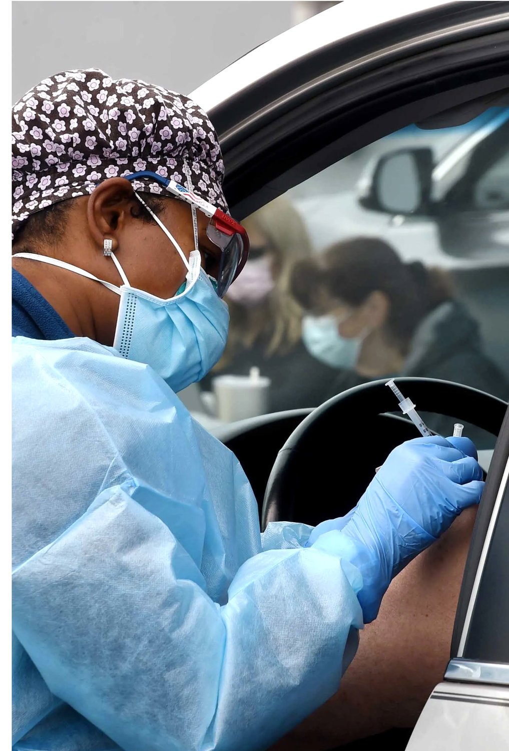 A health care worker administers a dose of the Pfizer-BioNTech COVID-19 vaccine to a patient during a drive-thru clinic held Jan. 29 during a Moberly  drive-thru vaccine clinic held at the parking lot of The Lodge in Rothwell Park.