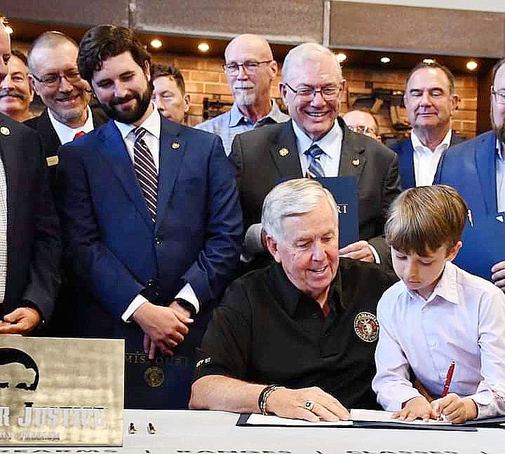 Missouri Governor Mike Parson is shown Saturday, June 19 with a young child during a signing ceremony for House Bill 85 concerning the Second Amendment Preservation Act. The act is meant to protect law-abiding gun owners from potential gun control legislation that could be passed in Washington, D.C.