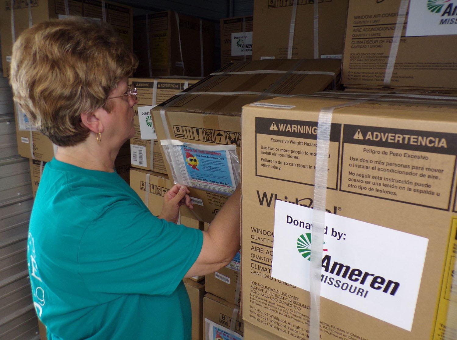 North East Community Action Corporation (NECAC) County Services Programs Director Linda Fritz looks over 80 air conditioners donated to the not-for-profit agency through Cool Down St. Louis and AmerenMissouri. The units will be distributed to NECAC clients who are elderly, disabled or have young children with health problems in counties served by Ameren. For more information, or to apply, call NECAC Randolph County Service Coordinator Patsy Redding at 660-263-6595. The NECAC Randolph County Service Center is at 1903 North Morley Suite B in Moberly.